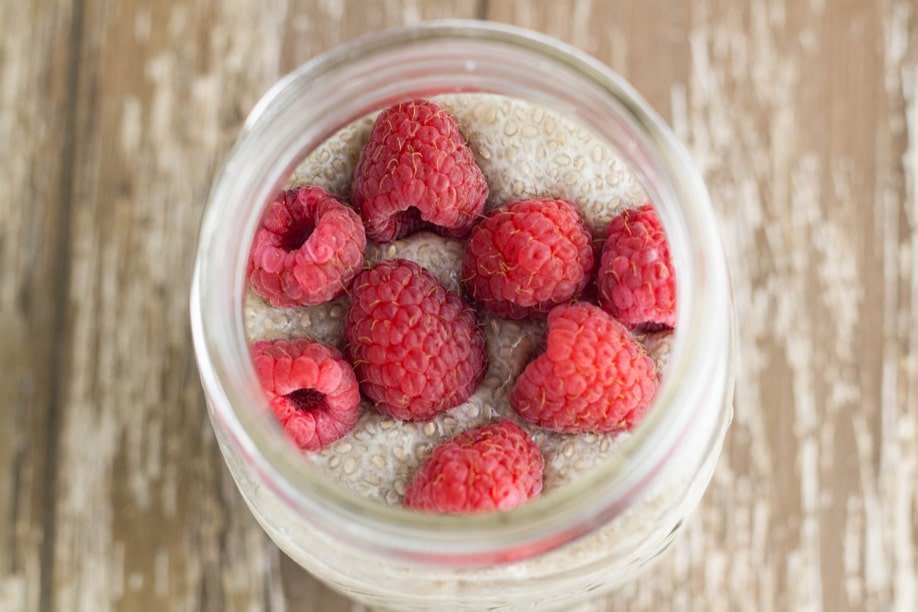 Chia pudding topped with fresh raspberries.