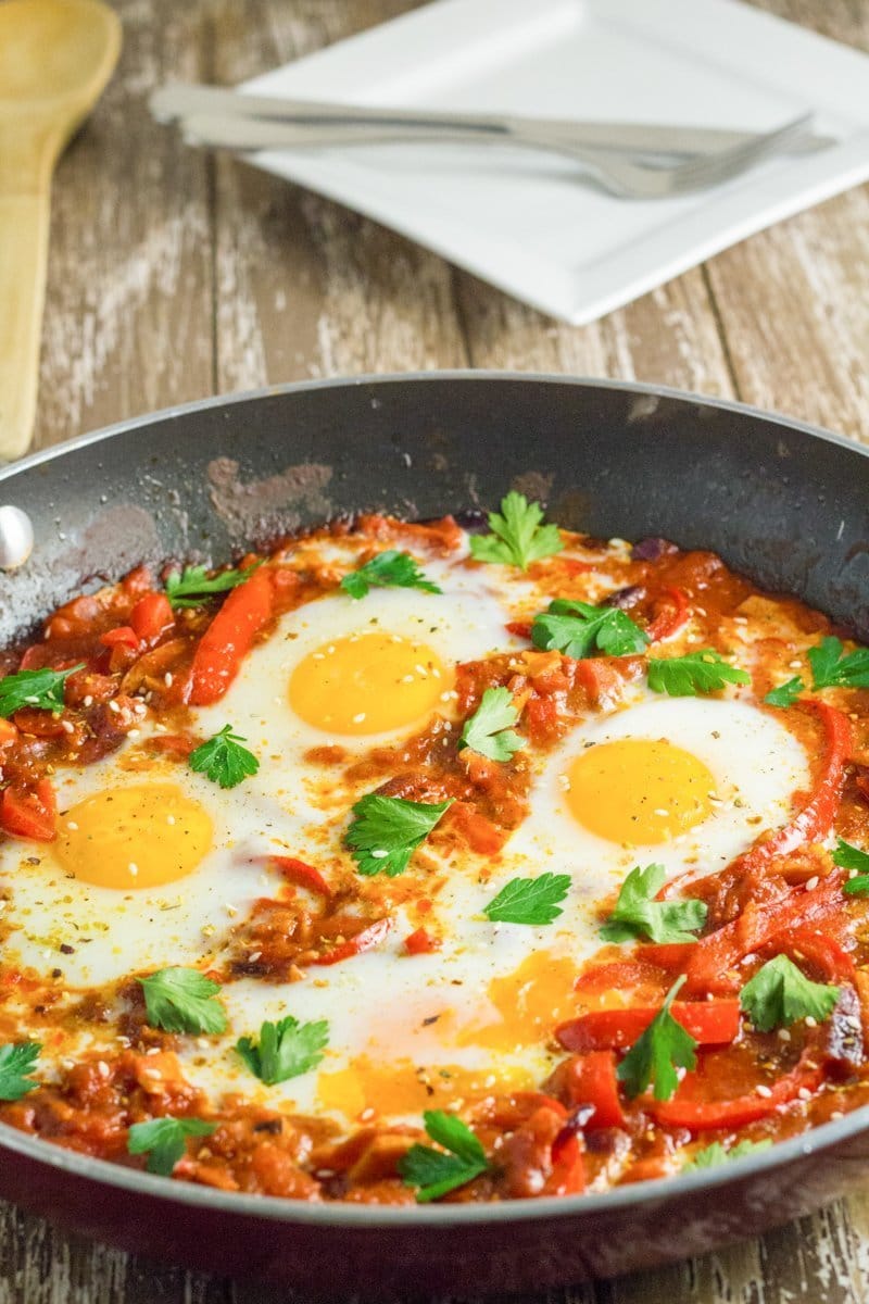 Skillet pan with Eggs poached in a tomato sauce with chilli peppers, onions and spices.