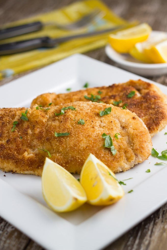 Two pieces of gluten free chicken on a plate.