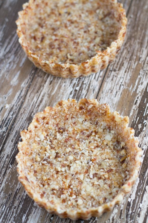 Preparing two tart bases using cling wrap.