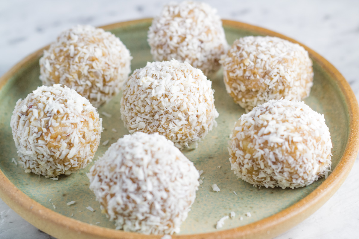 plate with raw caramel macadamia bliss balls