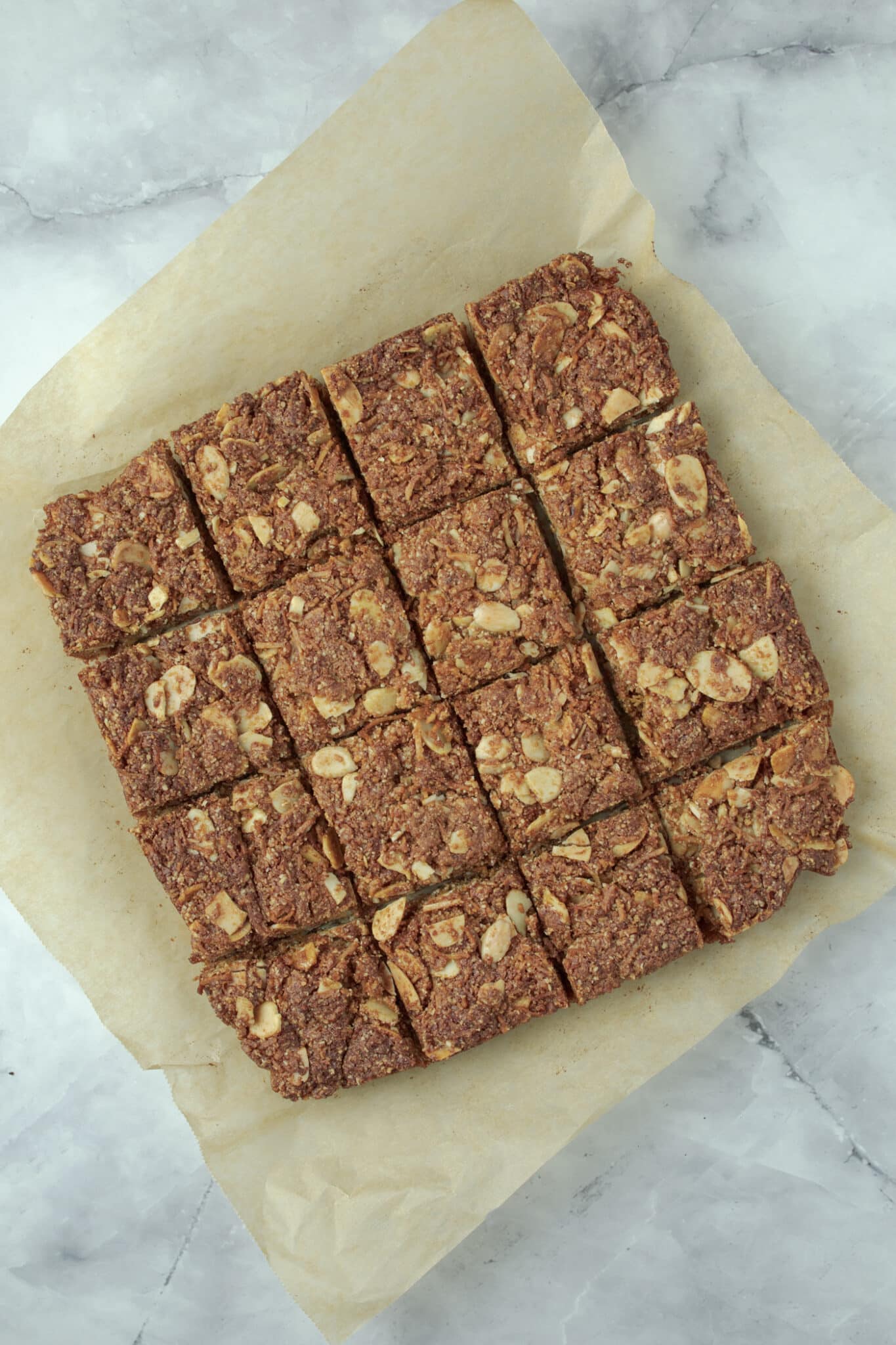 Anzac slice on baking paper cut into squares.