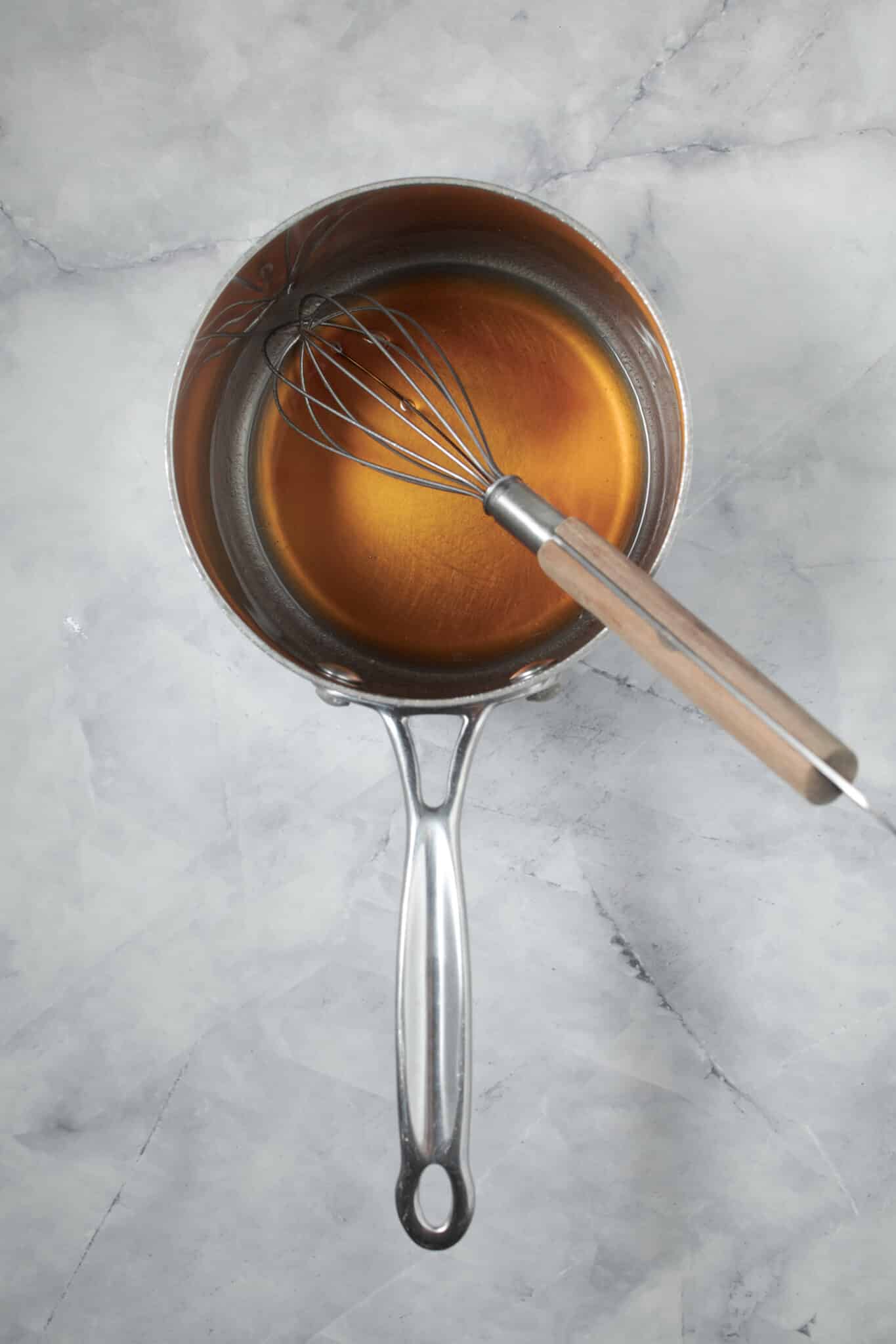 photo of the coconut oil and maple syrup whisked together in the saucepan