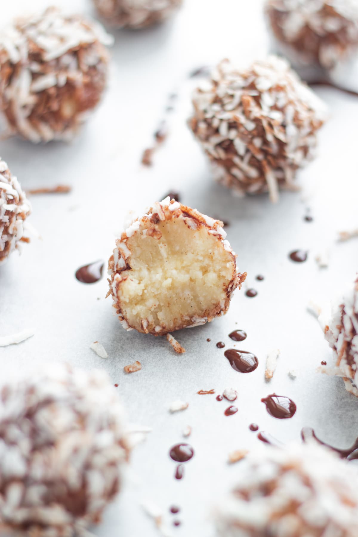 Lamington bliss balls on a baking tray lined with baking paper.