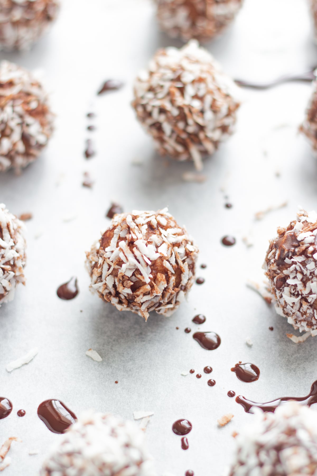 The bliss balls on a baking tray lined with baking paper.