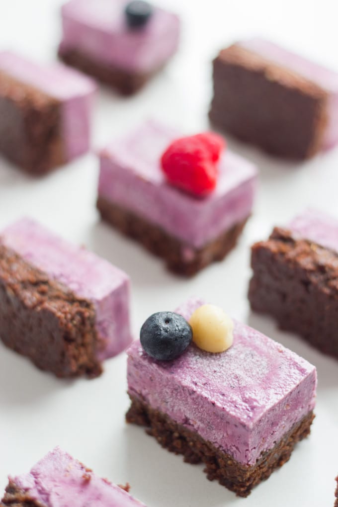 Raw Berry and Chocolate Brownie Slice bars on a white board.