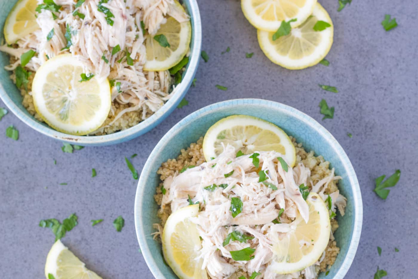 two bowls of pulled lemon garlic chicken.