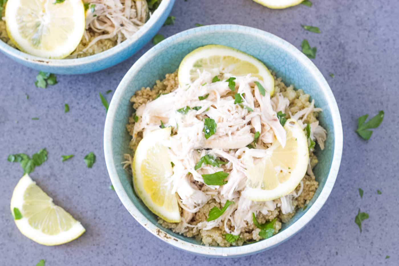 bowl of Slow Cooker Shredded Chicken on top of cooked quinoa.