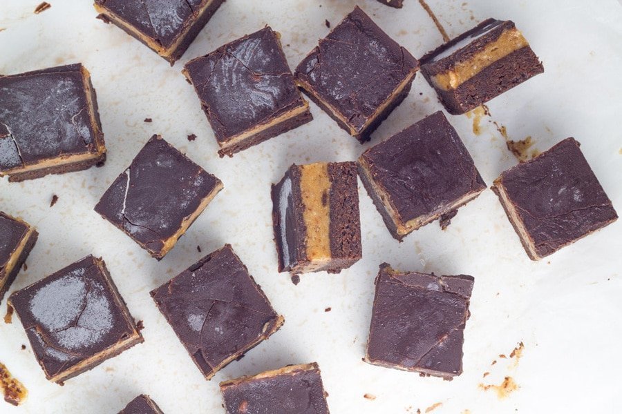 The caramel brownie slice bars on a white board.