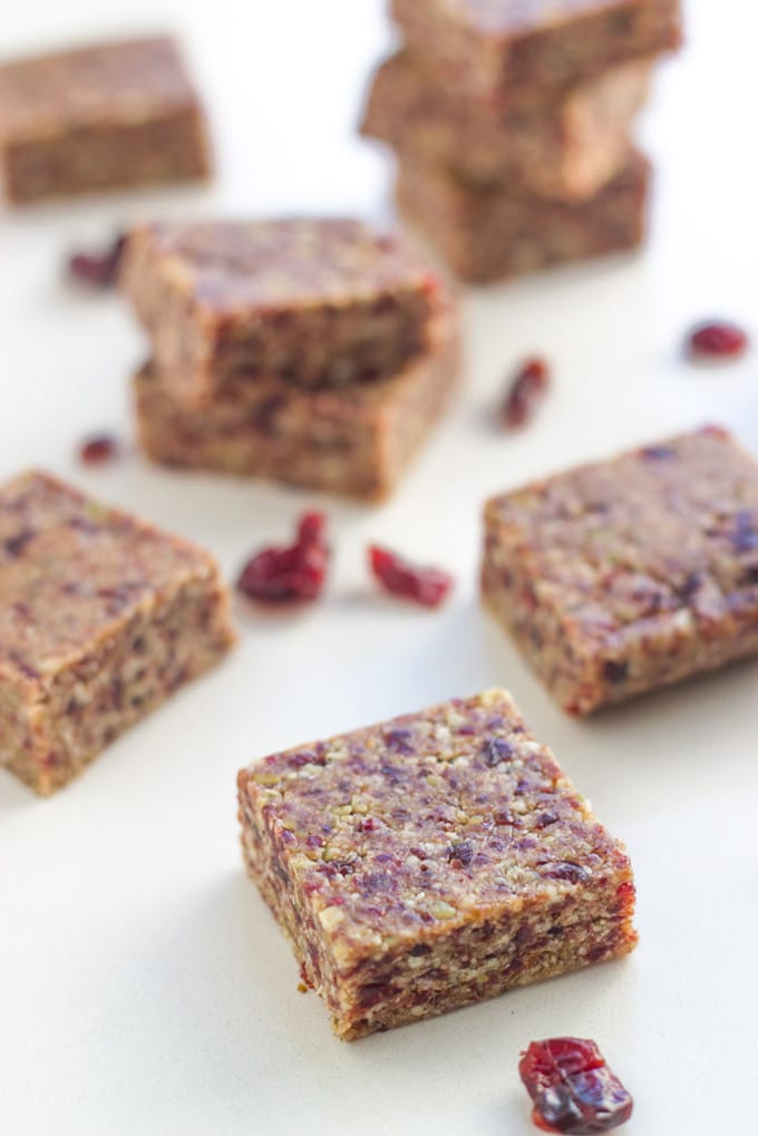 Raw Cranberry Date Bars on a white board.