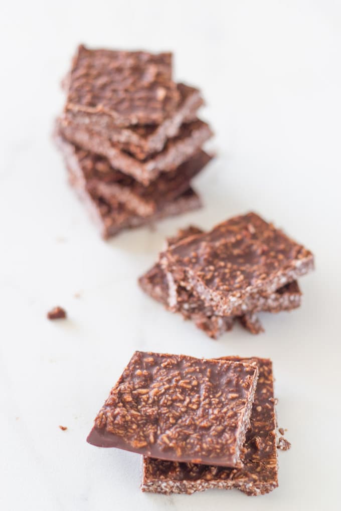 pieces of coconut chocolate on a white board.