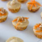 Raw mini carrot cake bites are the perfect mini dessert recipes to serve your guests. They are topped with an amazing macadamia frosting. So good!