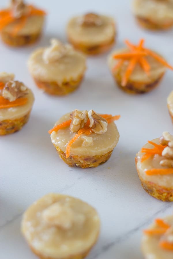 Raw mini carrot cake bites are the perfect mini dessert recipes to serve your guests. They are topped with an amazing macadamia frosting. So good!