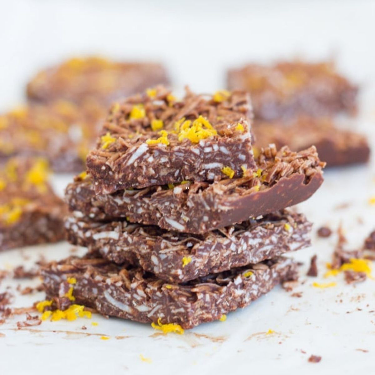 Stack of orange coconut chocolate pieces.