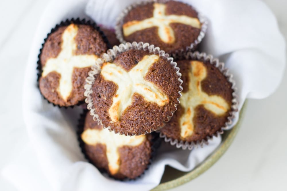 The cooked hot cross buns in a basket ready to eat.