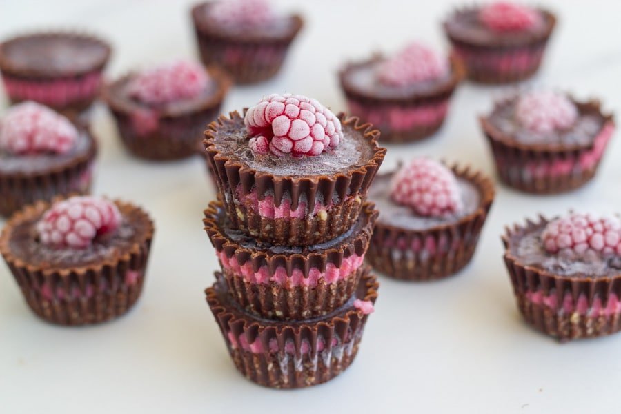 Chocolate raspberry bites on a white board.