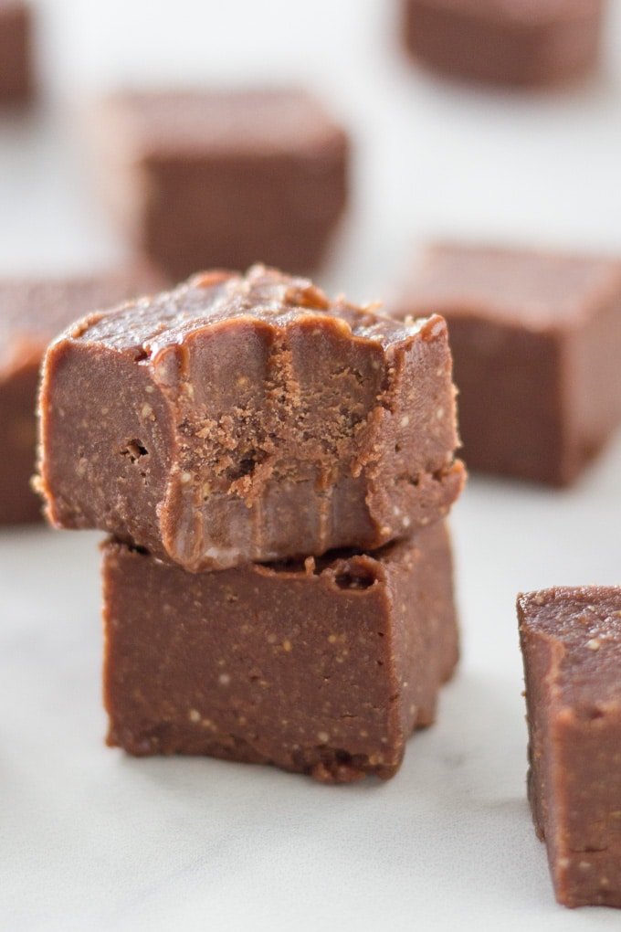 Stack of chocolate mint fudge with some of the fudge pieces surrounding it.