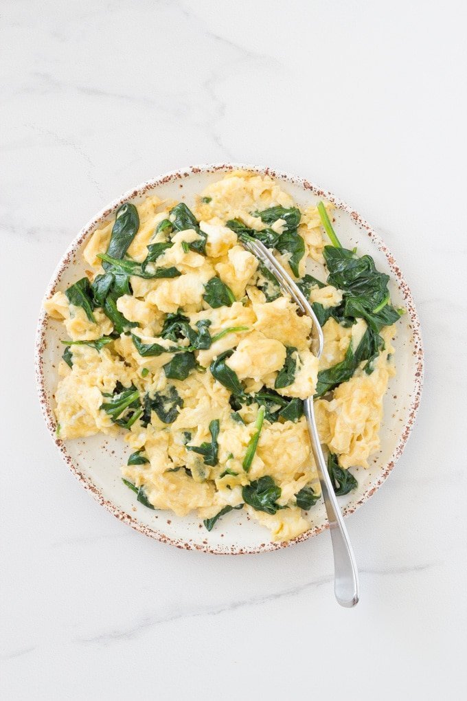 Plate of spinach scrambled eggs.