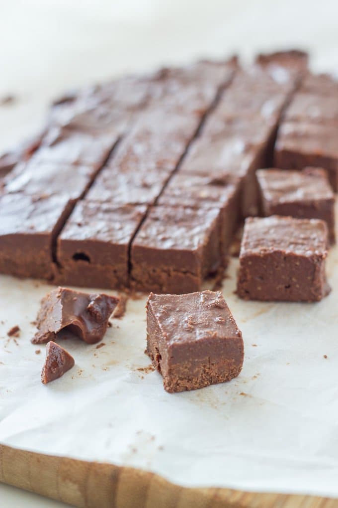 A piece of fudge with the rest of the sliced fudge behind it.