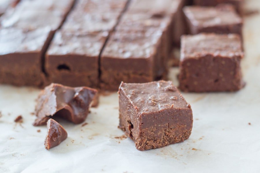  A piece of chocolate fudge with the rest of the fudge behind it.