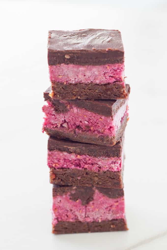 stack of 4 slices of raw chocolate raspberry brownies