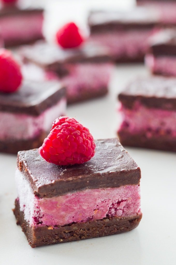 pieces of no-bake chocolate raspberry brownie on white surface