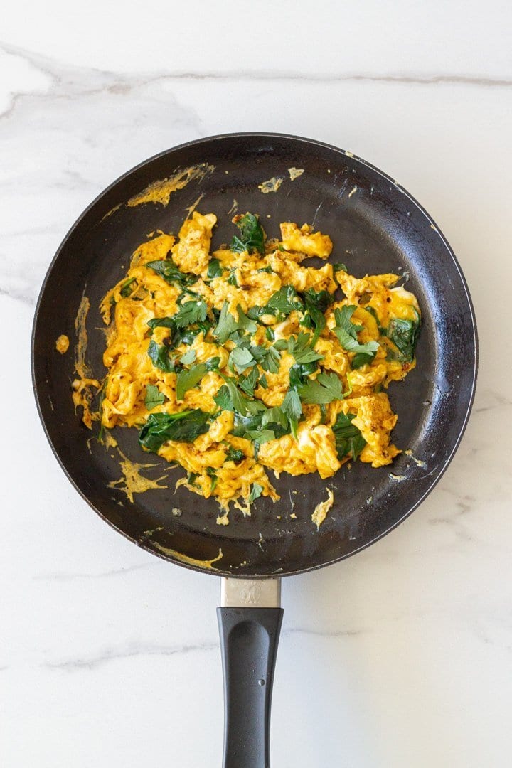 A skillet with cooked turmeric eggs.