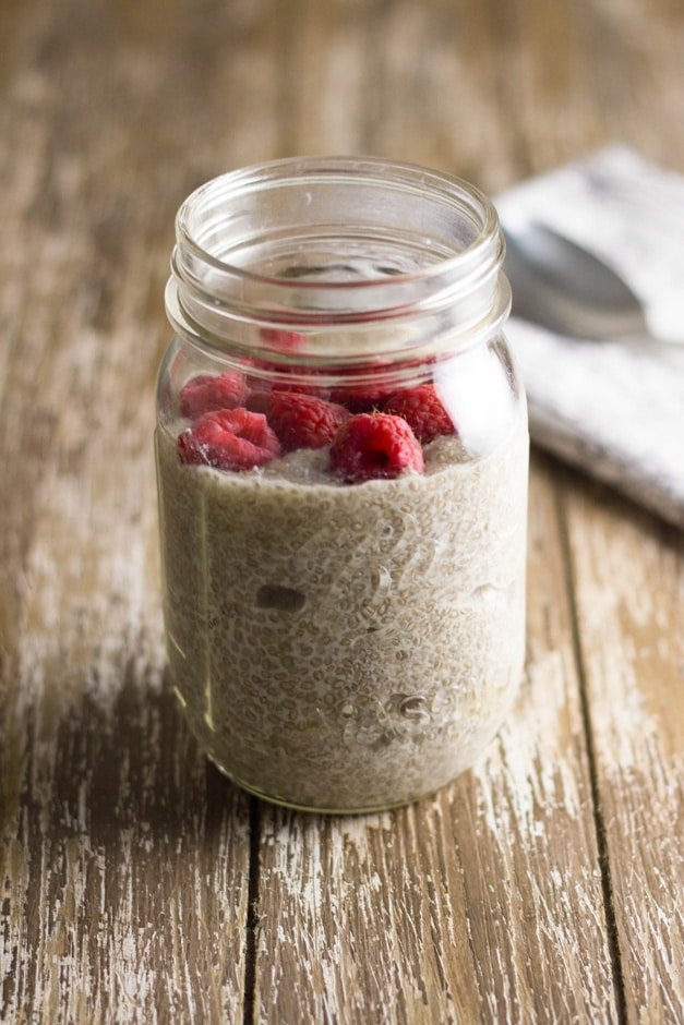 Vanilla chia pudding in jar topped with raspberries.