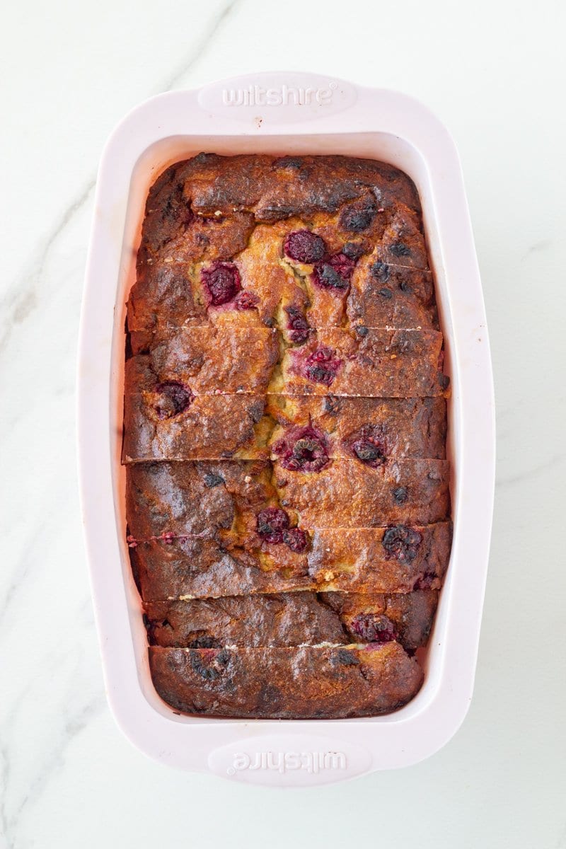 Cooked raspberry bread in a loaf pan.