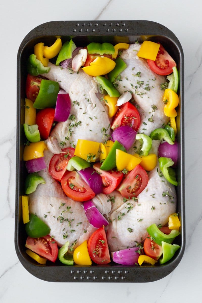 One tray oven baked chicken and vegetables is your weekly go-to roast chicken dish. This easy to make one pan dinner is made with a delicious marinade and easy to prep vegetables.