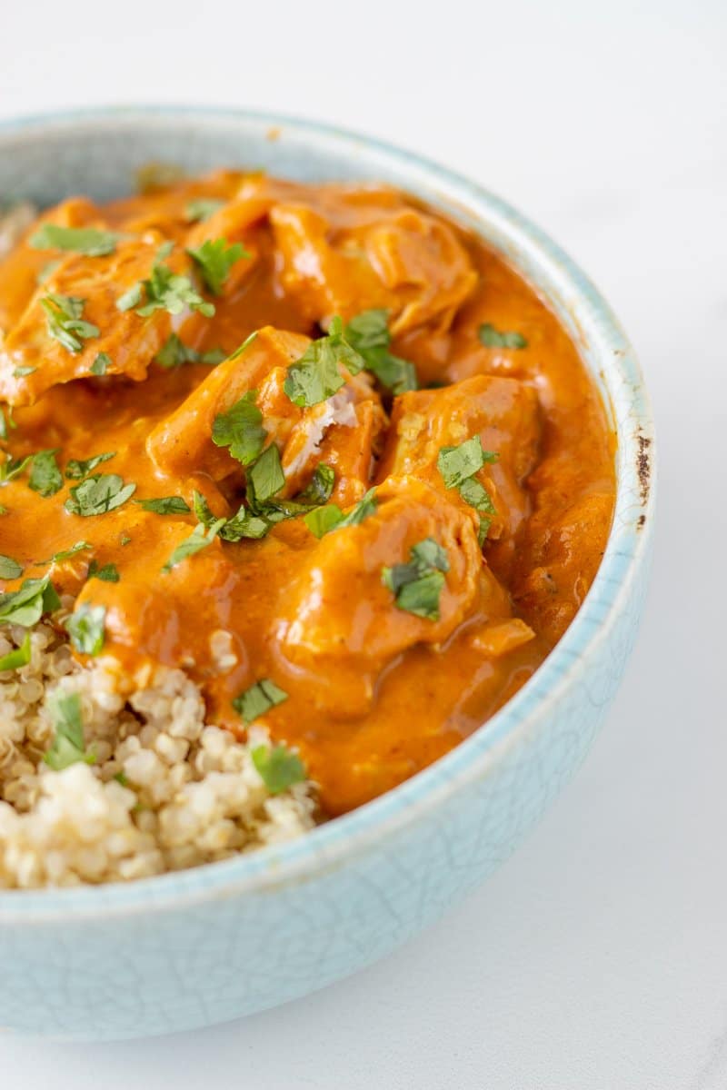 A bowl of chicken tikka marsala served with quinoa.