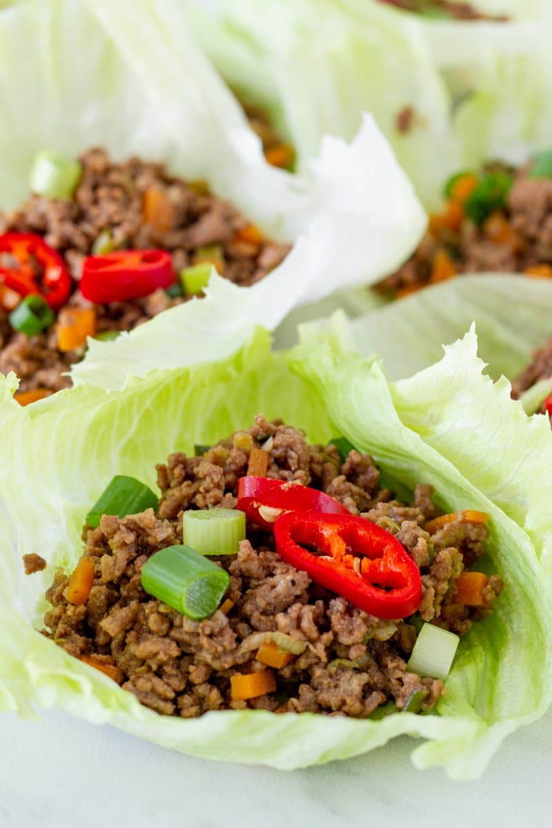 Four beef lettuce wraps on a plate