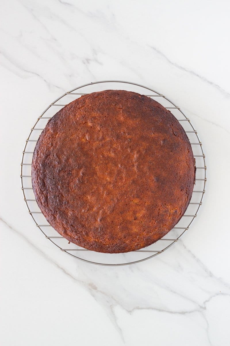 The cake just out of the oven and cooling on a wire rack.