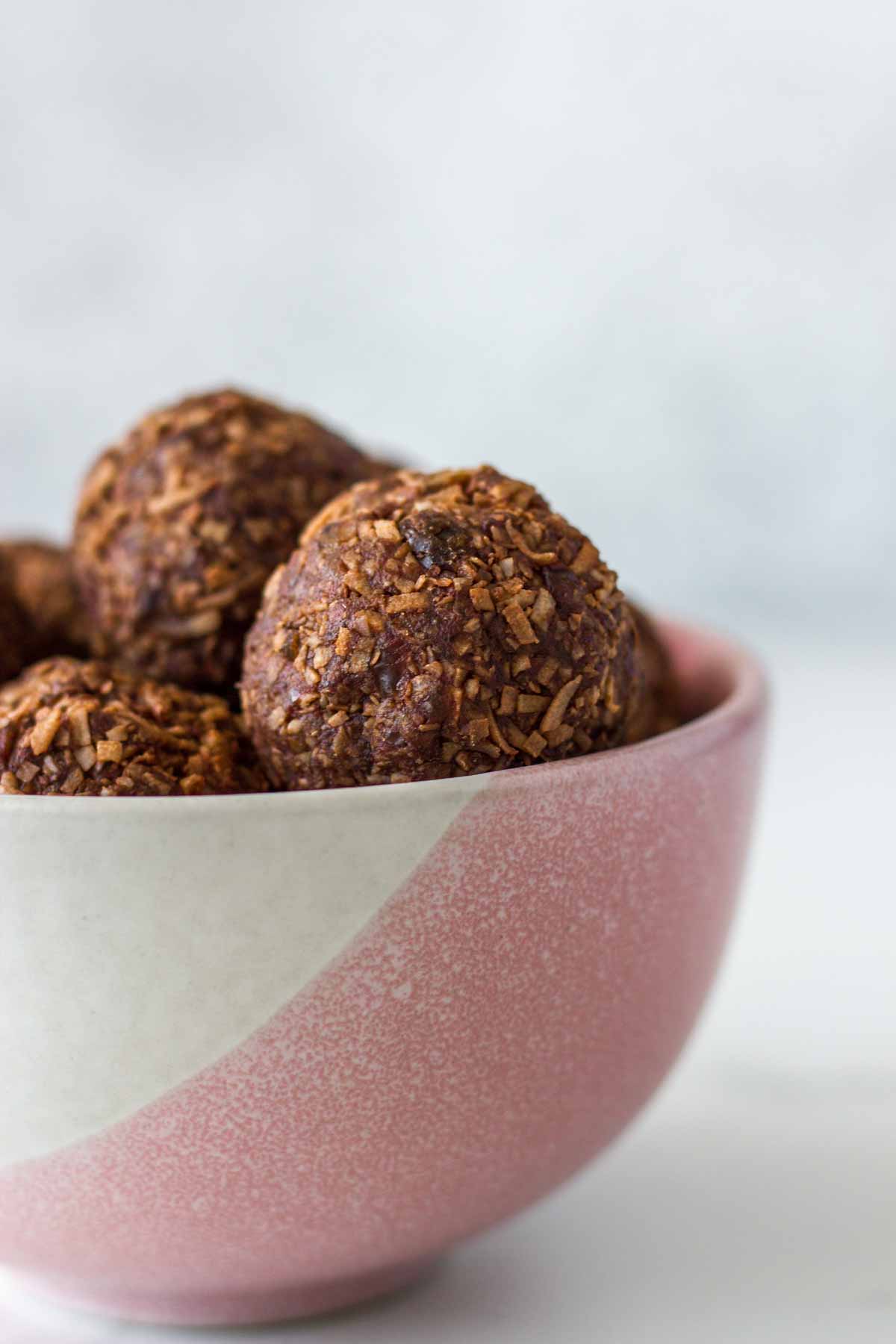 Peppermint Coconut Rough Bliss Balls in a pink and white bowl.