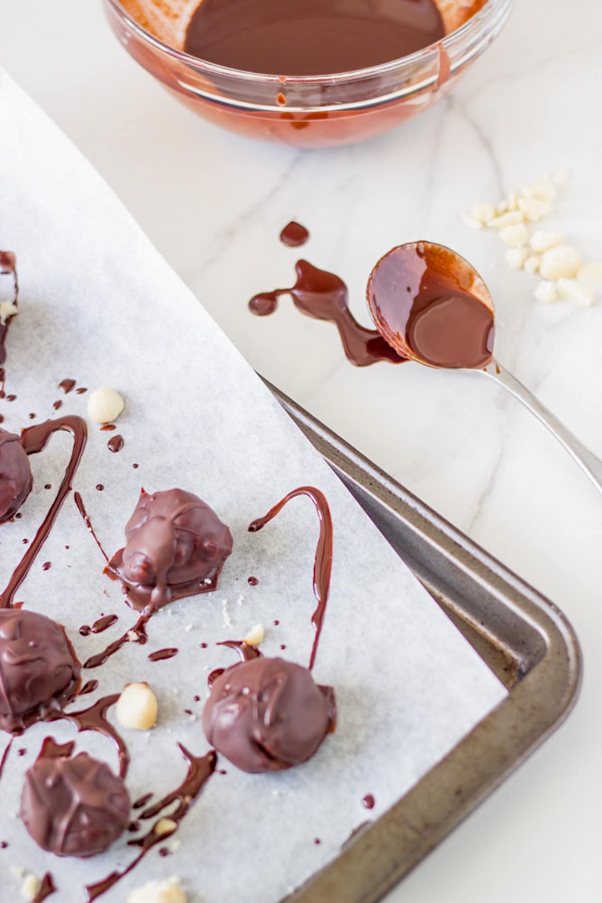 Making the truffles with raw chocolate and macadamias.