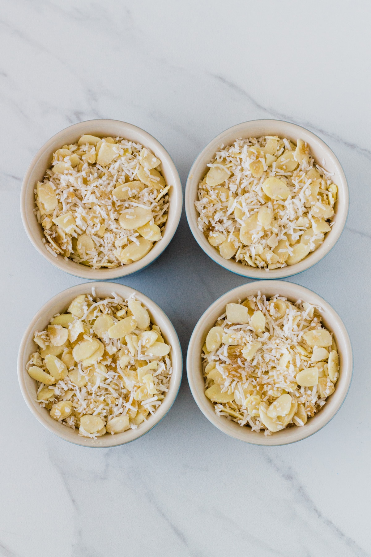 photo of 4 ramekins with the crumble mixture placed on top of the cooked apple