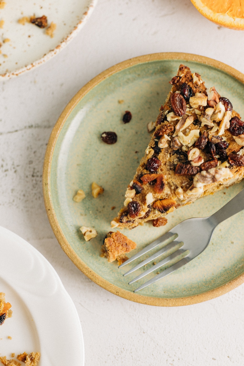 Slice of fruit cake on a green plate.