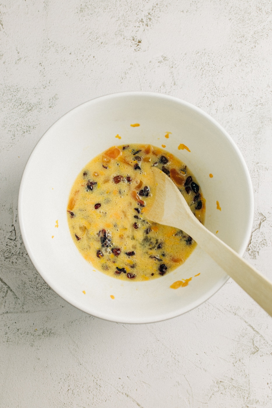 Image of fruit and wet ingredients combined in a mixing bowl