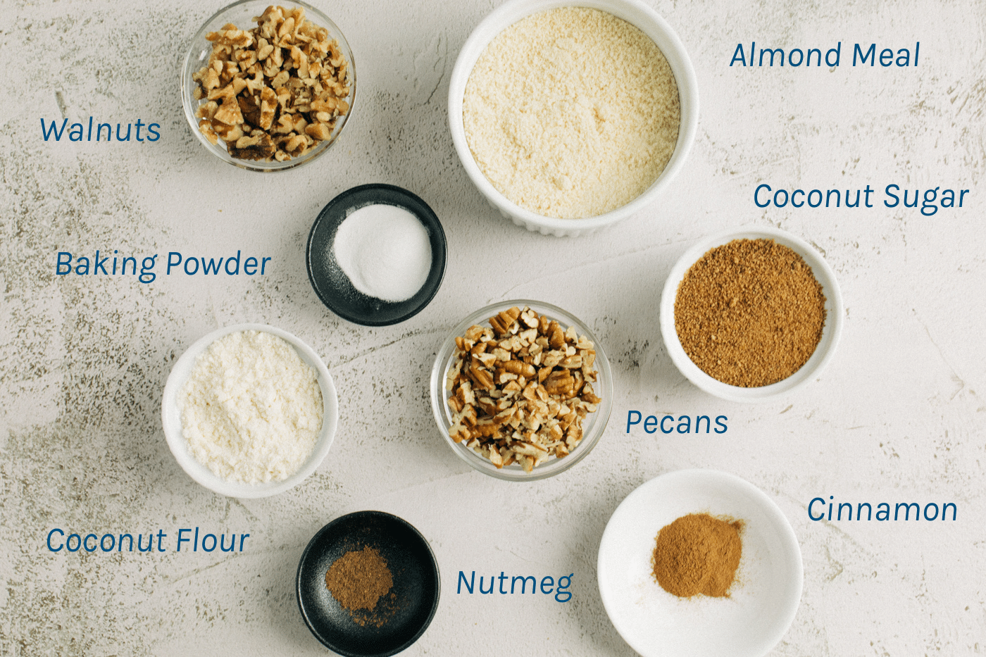 Dry Ingredients - walnuts, almond meal, baking powder, coconut sugar, coconut flour, nutmeg, pecans, cinnamon.