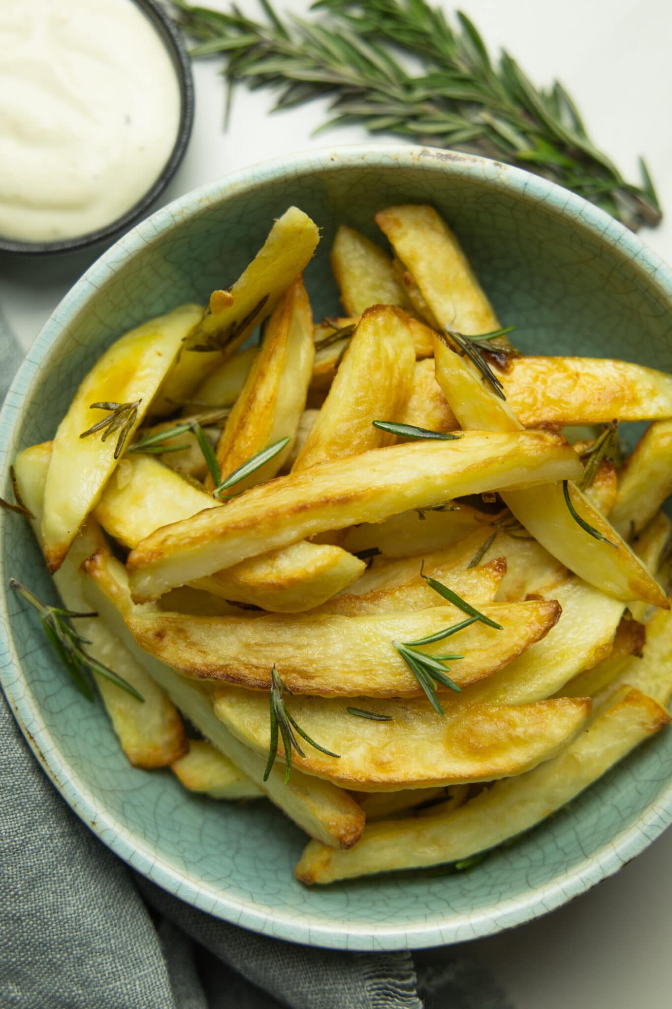 photo of a bowl of healthy oven baked fries with aioli and rosemary