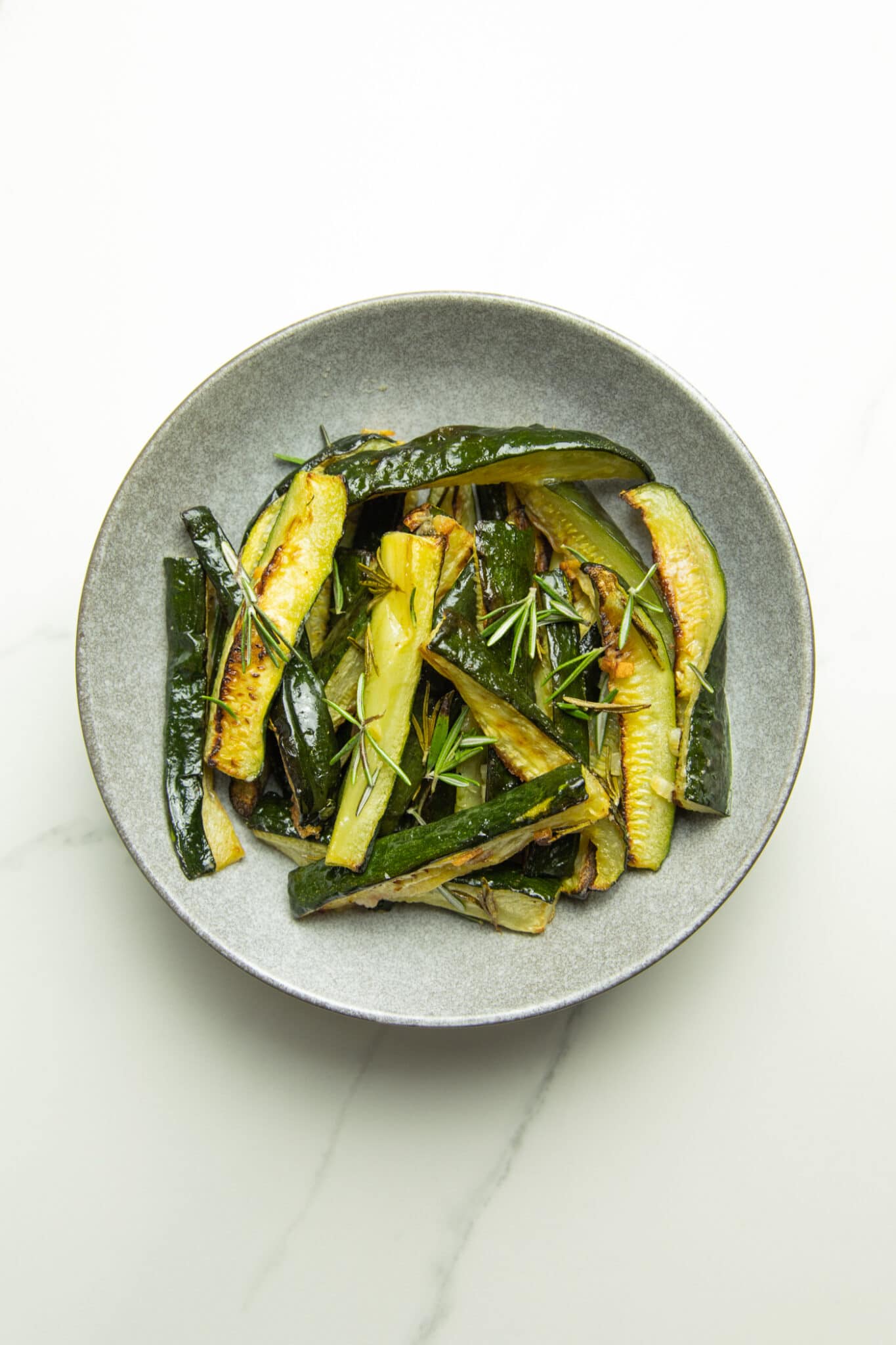 Bowl of oven baked zucchini wedges.