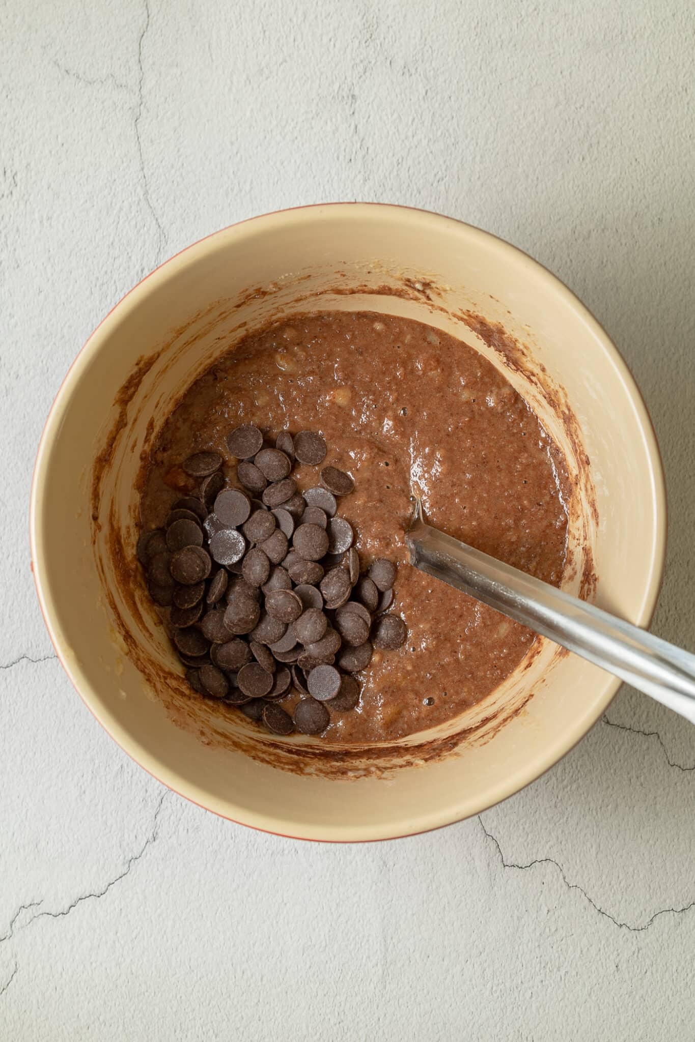 bowl with choc chips added to the muffin mixture