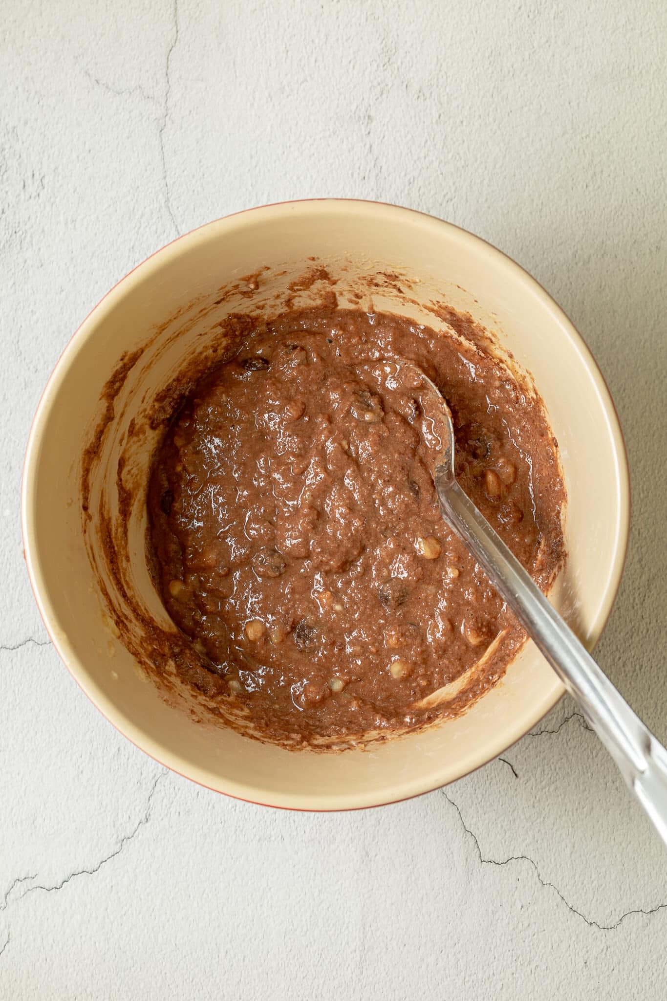 photo showing the choc chips folded through the muffin mixture