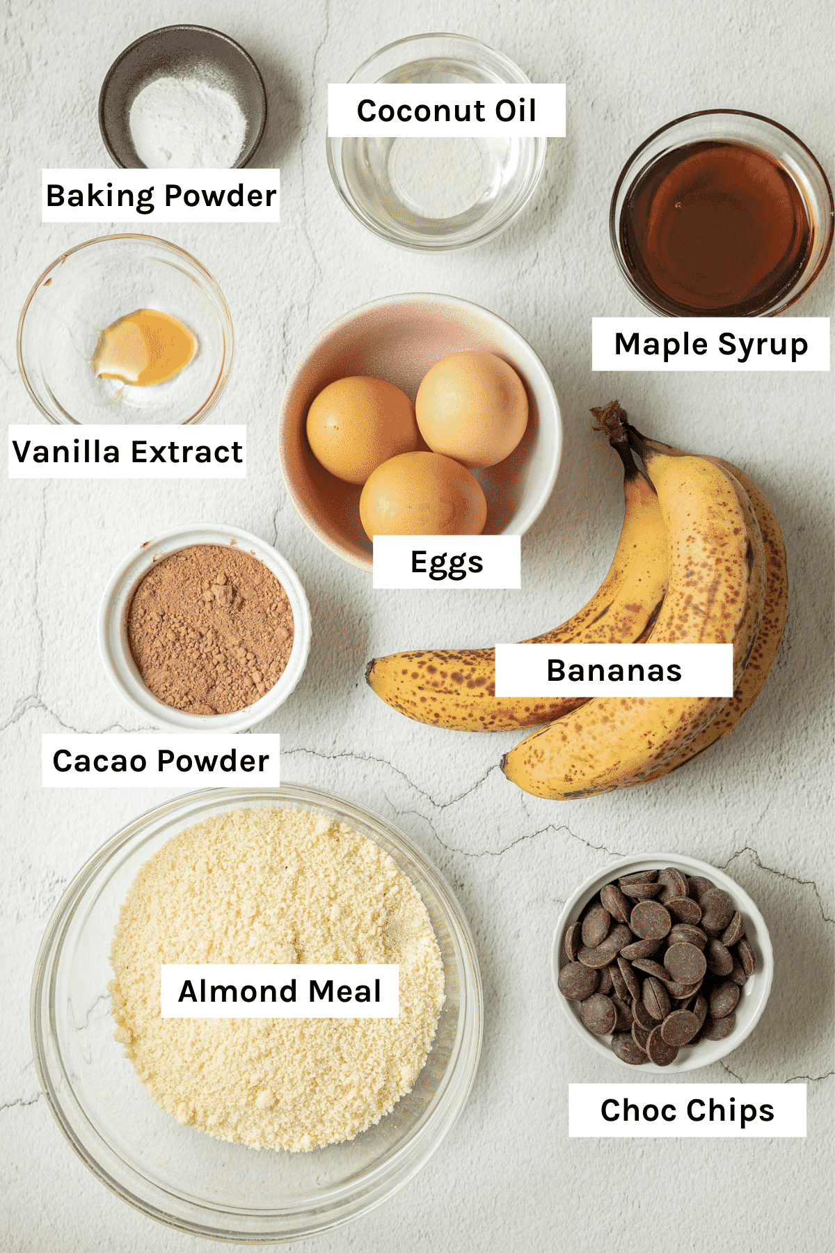 Ingredients. Banana, maple syrup, baking powder, coconut oil, vanilla extract, eggs, cacao powder, almond meal, chocolate chips.