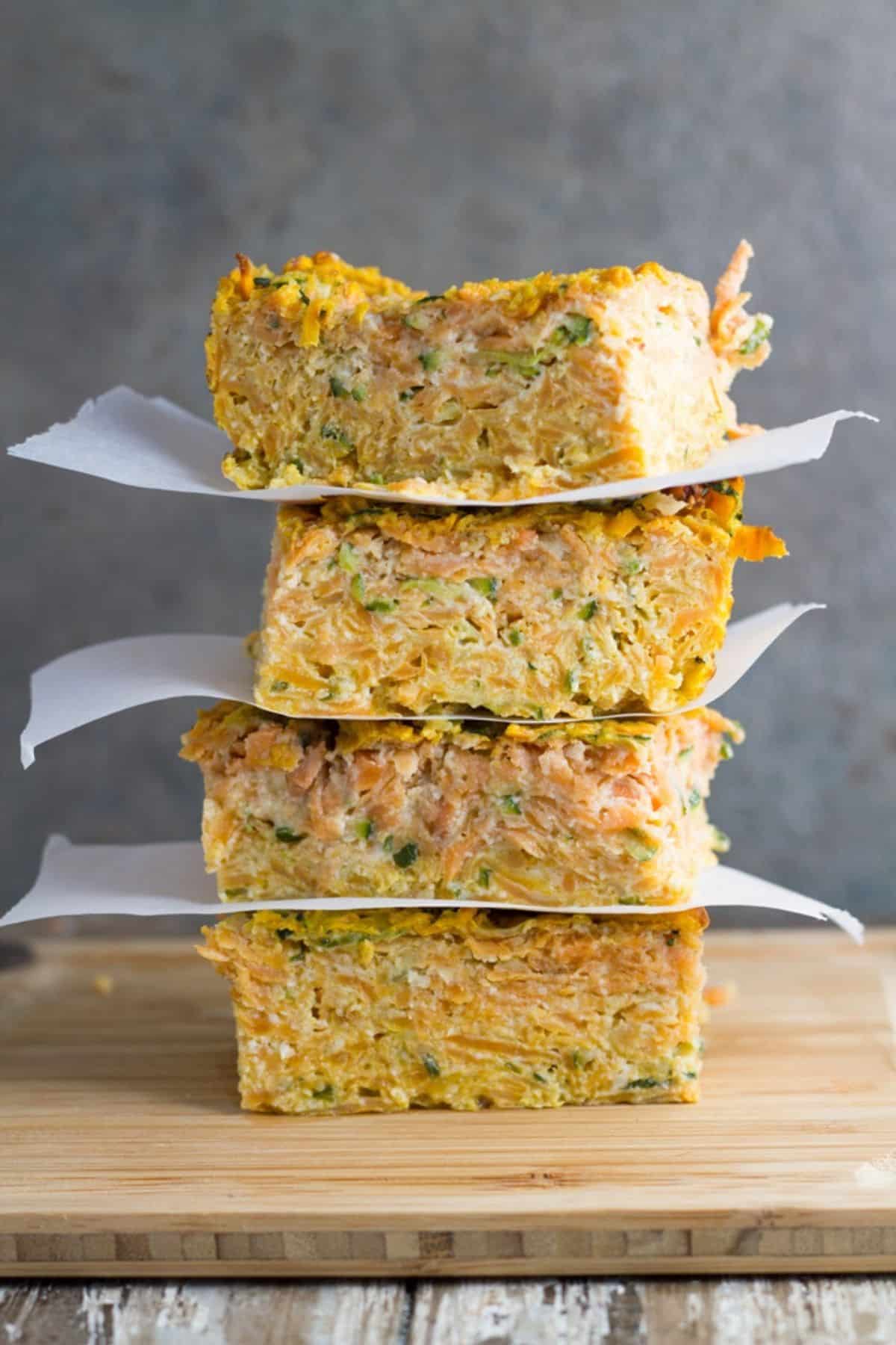 Four pieces of Zucchini and Sweet Potato Slice stacked on top of each other. 