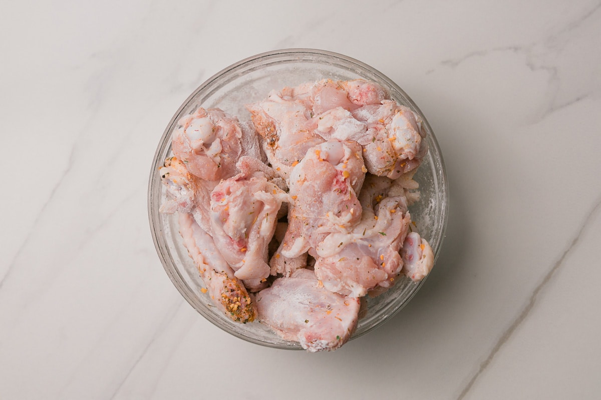 Chicken wings coated in the flour and spices.